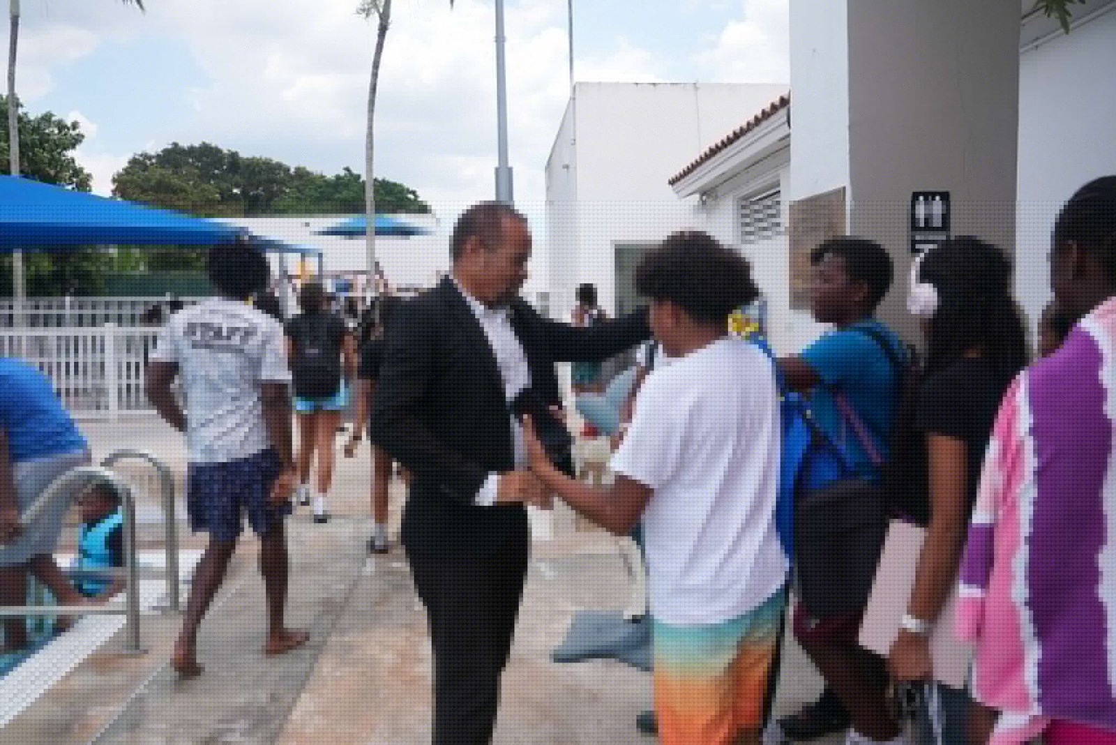 Mayor Borgelin shakes hands with campers at the city aquatic complex