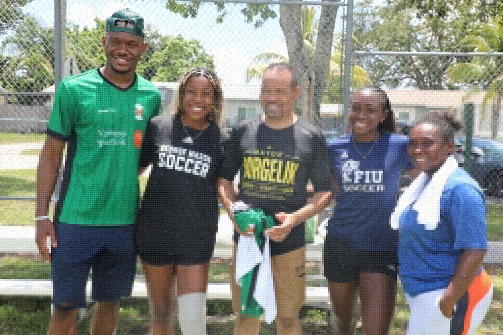 Players, coaches and Mayor Borgelin pose together at the soccer clinic